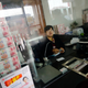 An employee of Jiangsu Sheyang Rural Commercial Bank talks to a customer at one of the banks branches in Jiangsu province.